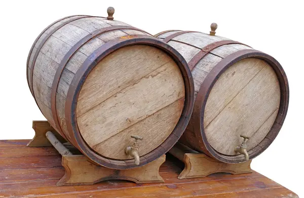 Old oak barrels on a wooden table on white background