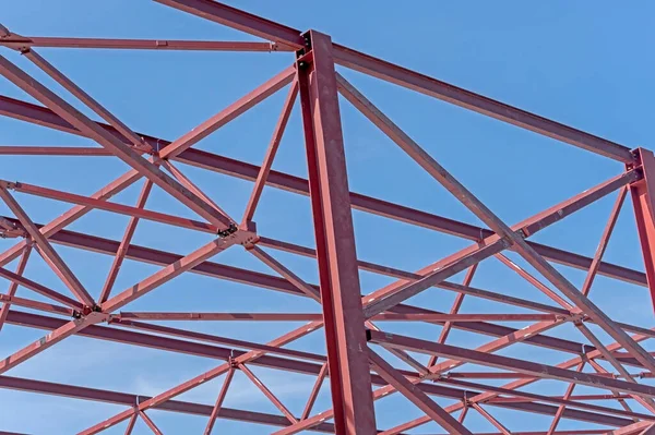 Steel Frames of A Building Under Construction on a background blue sky