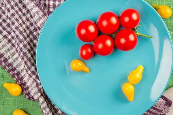 Cherry tomatoes. Cherry tomatoes on a blue plate with a decor.