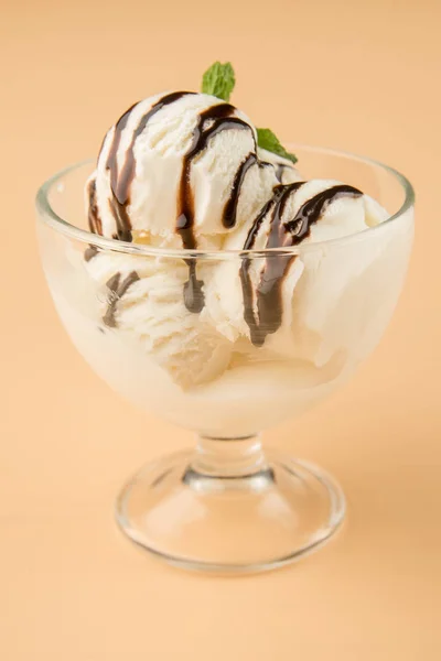 Ice cream with topping in a glass beaker