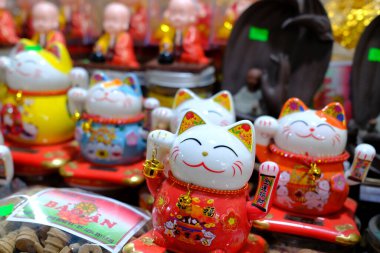 Budist ve Taoist dini eserlerin deposu. Şanslı Çinli kedi sallıyor. Şans tılsımı. Vietnam.