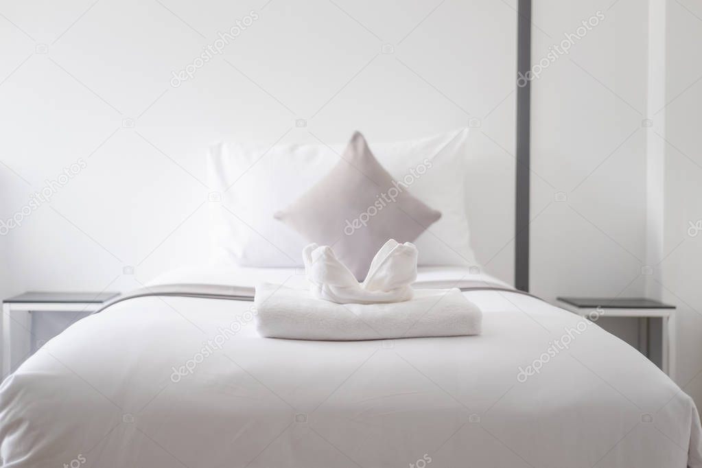 White fresh towel on single bed in bedroom in the hotel