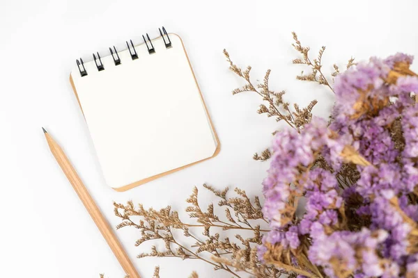Draufsicht auf einen leeren Zettel mit Bleistift und Blumenstrauß — Stockfoto