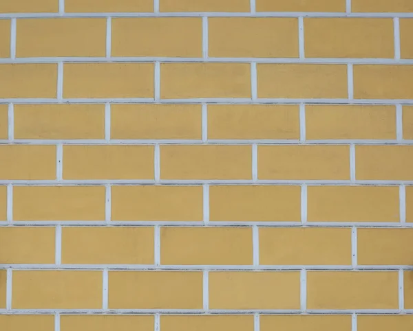 White-yellow wall with a large imitation brick