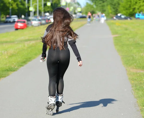 A girl on roller skates rides on a Park track, Podvoysky ulitsa, Saint Petersburg, Russia June 2020