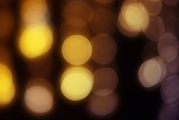 Background of defocused lights of orange and purple colors