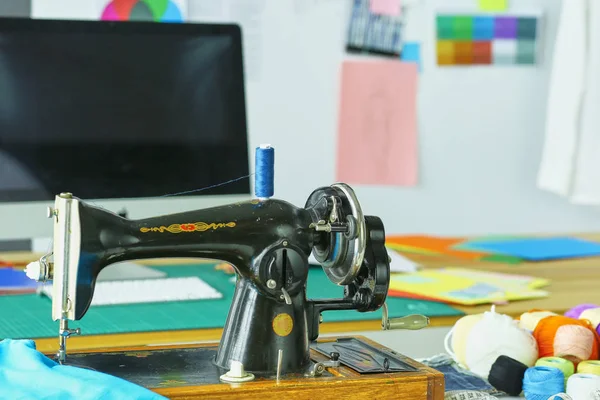จักรเย็บผ้าย้อนยุคบนเดสก์ท็อปเสื้อผ้าดีไซเนอร์ — ภาพถ่ายสต็อก