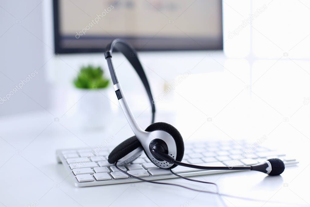 Call center and customer service help desk. VOIP headset on laptop computer keyboard