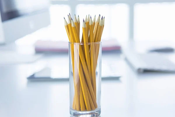 Graphite pencils in a glass cup on the office table. Concept — Stock Photo, Image