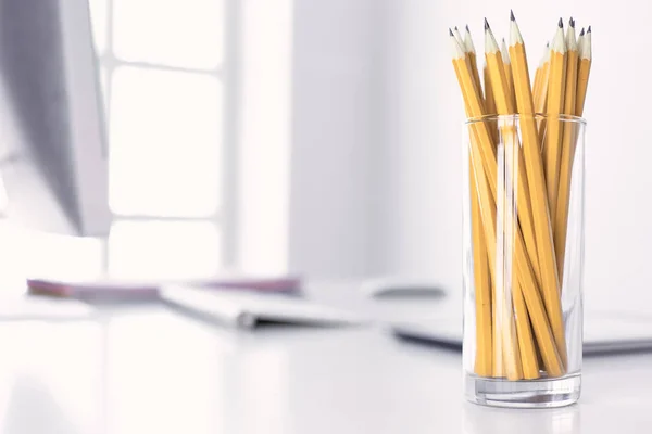 Graphite pencils in a glass cup on the office table. Concept — Stock Photo, Image