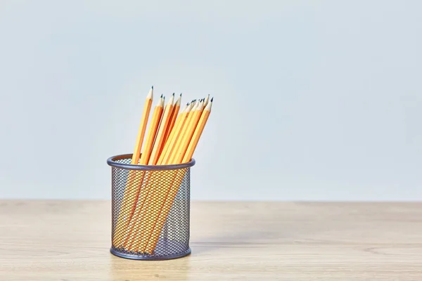 Graphite pencils in a metal grid-container. Concept — Stock Photo, Image