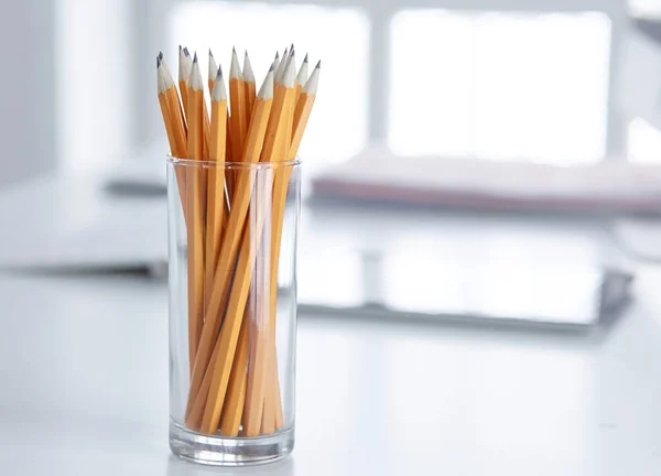 Graphite pencils in a glass cup on the office table. Concept — Stock Photo, Image