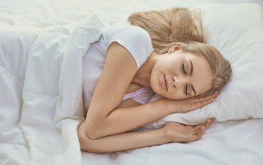 Güzel kız yatakta yatarken yatak odasında, uyuyor