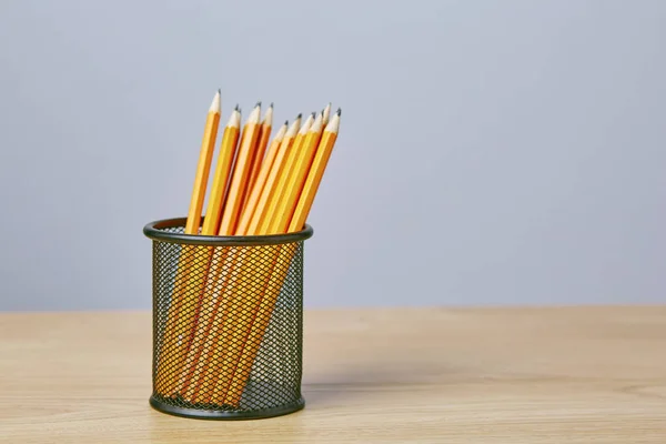 Graphite pencils in a metal grid-container. Concept — Stock Photo, Image