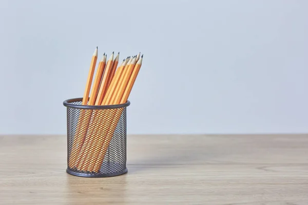 Graphite pencils in a metal grid-container. Concept — Stock Photo, Image