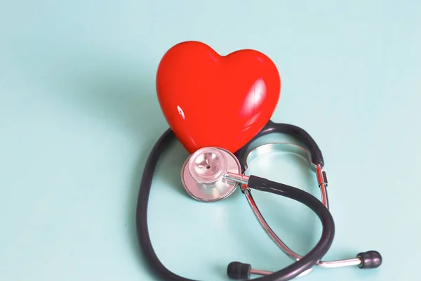 Red heart and a stethoscope on desk — Stock Photo, Image