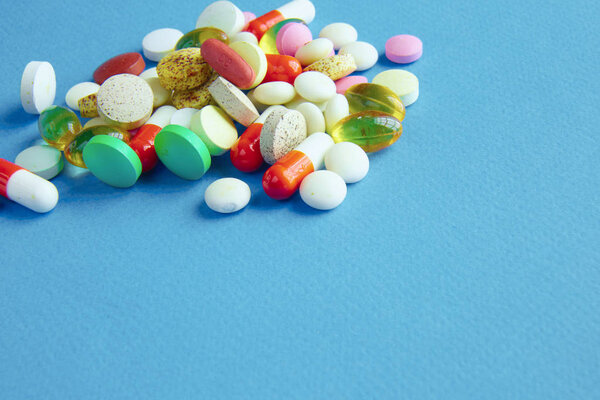 Assortment of pills, tablets and capsules on table