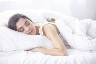 güzel genç kadın yatakta sabah tadını çıkarma. Güzel Model yüz kamera seksi görünüyor