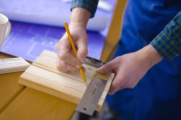 Profession, carpentry, woodwork and people concept - carpenter testing wood plank evenness at workshop — Stock Photo, Image