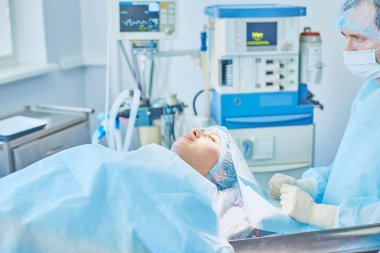 Birkaç doktor hasta operasyon masası üzerinde onların çalışma sırasında çevreleyen. Takım cerrahlar ameliyathane içinde işte