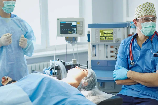 Several doctors surrounding patient on operation table during t — Stock Photo, Image