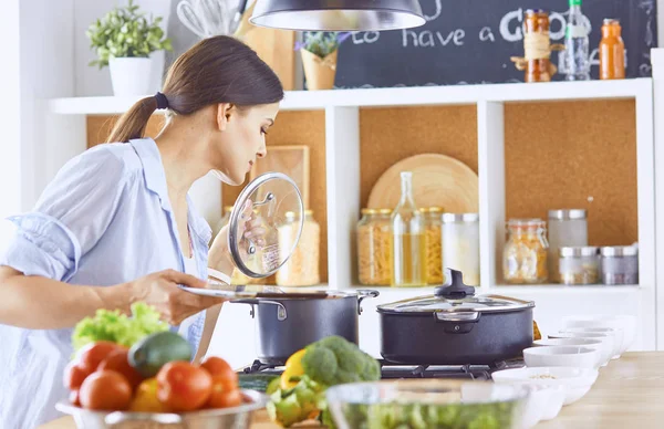 若い女性は、台所で食べ物を準備します。健康食品 - 野菜 — ストック写真