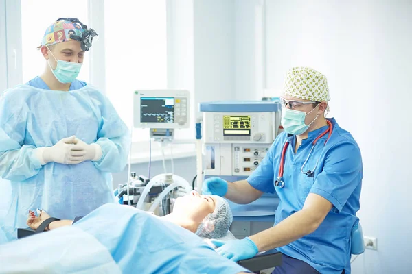 Several doctors surrounding patient on operation table during t — Stock Photo, Image