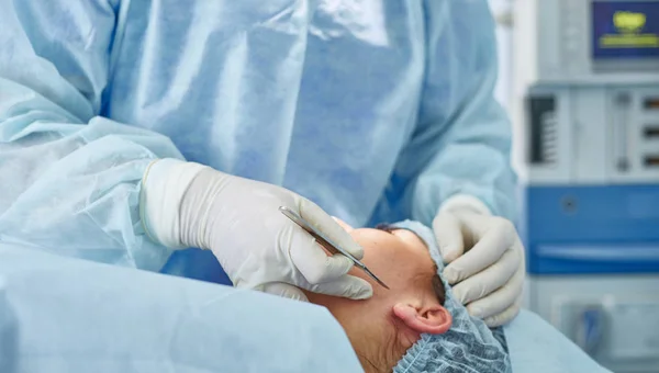 Several doctors surrounding patient on operation table during t — Stock Photo, Image