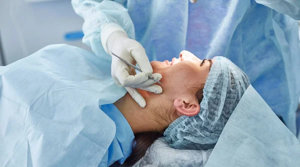 Several doctors surrounding patient on operation table during t — Stock Photo, Image