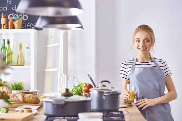 Bir bardak portakal suyu ile mutfakta masada kız