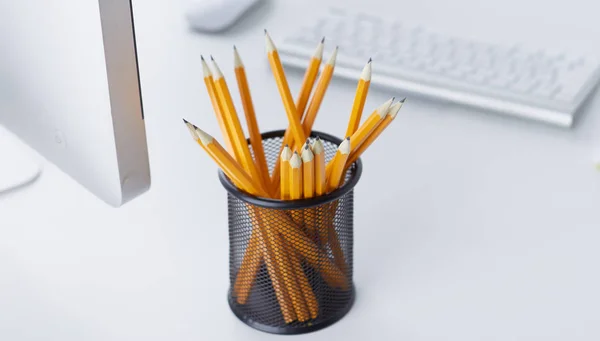 Graphite pencils in a glass cup on the office table. Concept. — Stock Photo, Image
