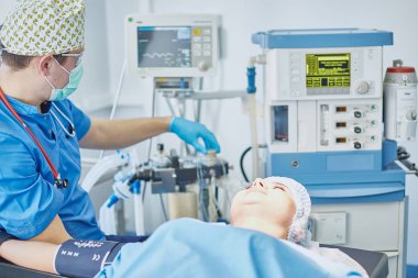 T sırasında ameliyat masasında hasta çevreleyen birkaç doktor