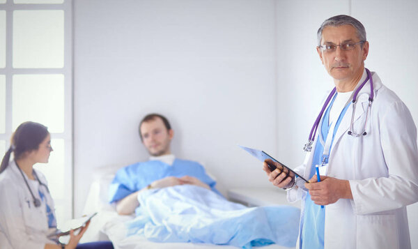 Doctor checking heart beat of patient in bed with stethoscope