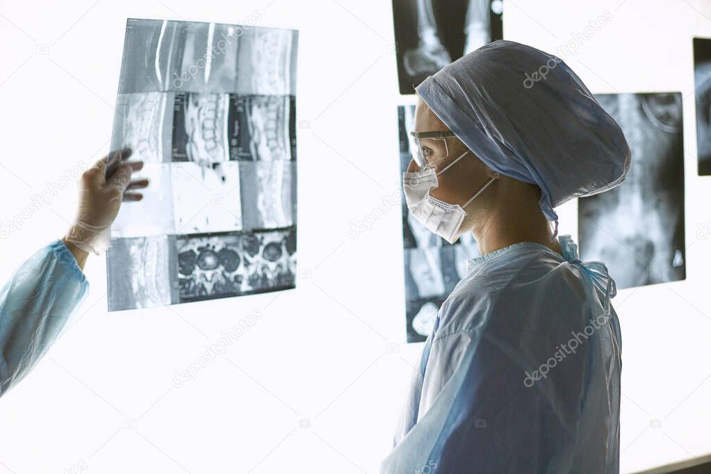 Two female women medical doctors looking at x-rays in a hospital