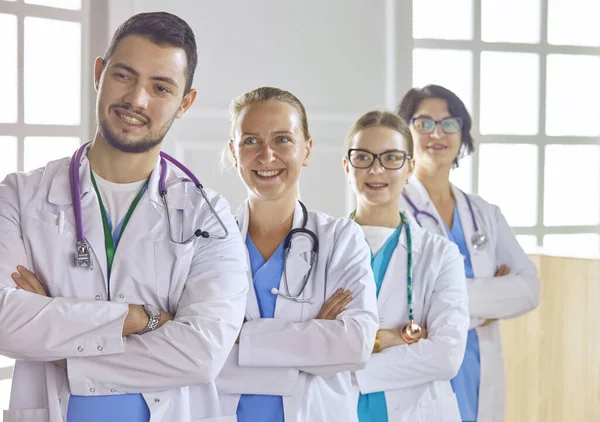 Smiling team of doctors and nurses at hospital — Stock Photo, Image