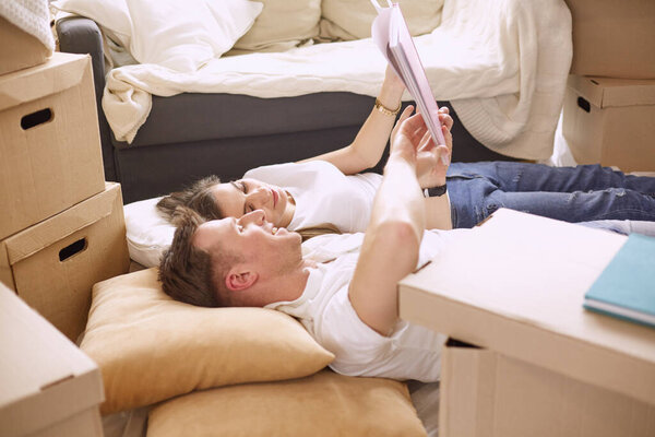 Young Vietnamese family looking through family photo album