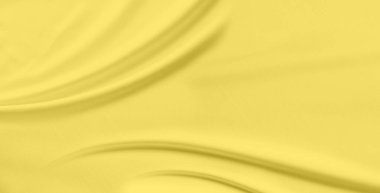 Close-up soft yellow-gold silk fabric with gentle flowing curves and graceful waves. Fabric subtle sheen and fine texture catching light create soft shadows and highlights accentuate smooth drapes
