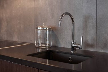 Dikdörtgen bir tasarımcı evye gri dokulu duvara su dokunun krom ile detay