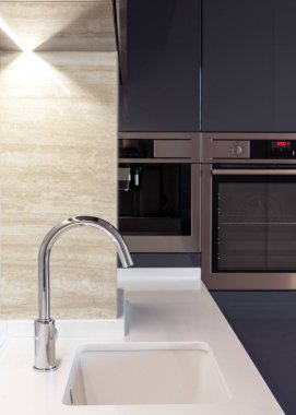 Yeni modern mutfak yapılı içinde fırın ve krom musluk suyu. LED ahşap aydınlatma