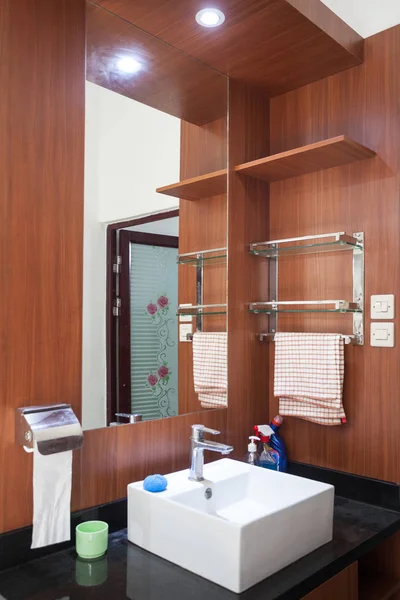 Element of bathroom interior in the house. Wash basin, white sink, mirror, switch and socket in the bathroom