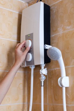 Yakın çekim el duş odasında elektrikli kazan suyu sıcaklığı ayarlama