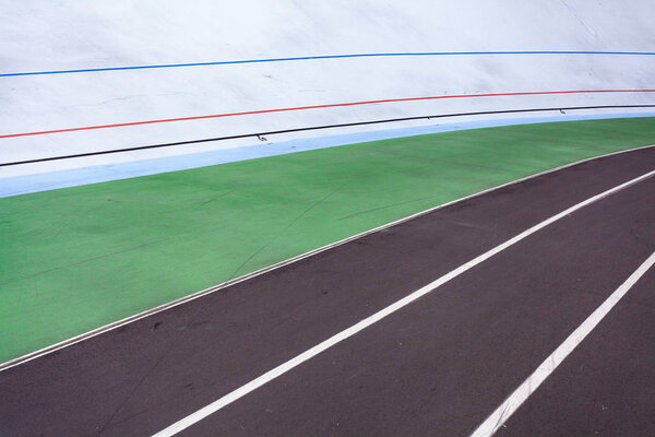 Leisure, lifestyle concept. High angle top view cropped photo of new empty modern public bicycle track in the open air with colored marking line for marathon or sprint run