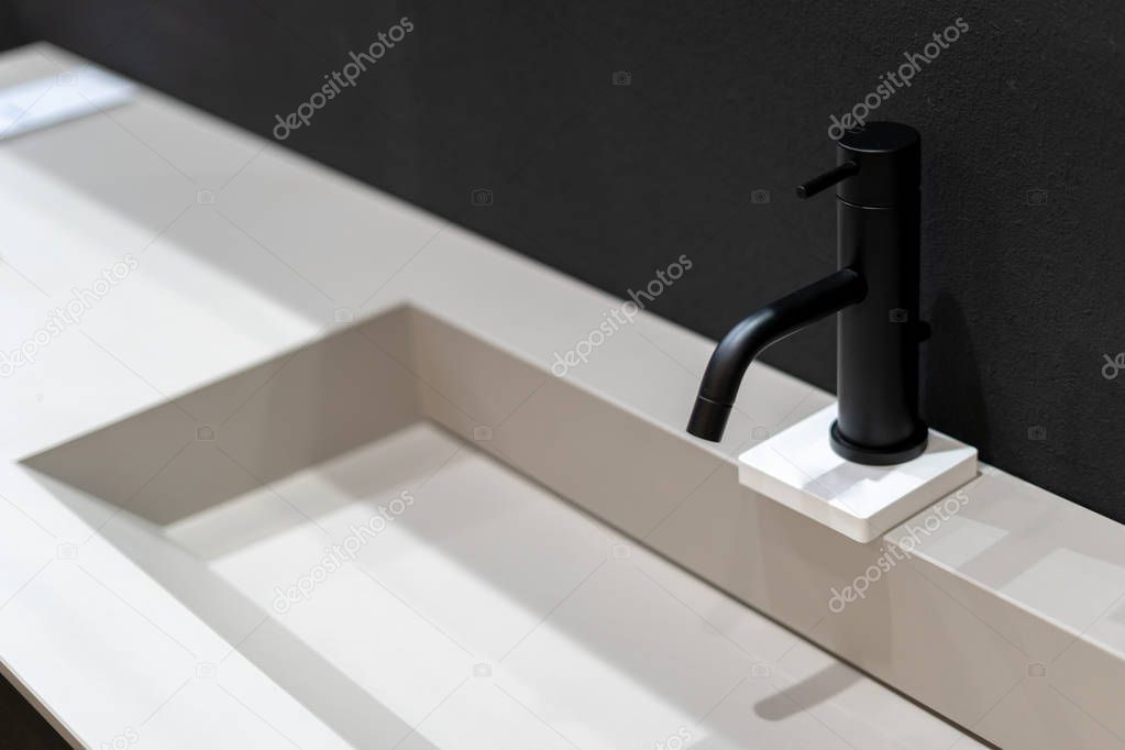 Side view photo of black mixer cold hot water in modern faucet bathroom over white sink