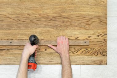 Tornavida kullanan adam tahta masa üstü tahtabağlamak