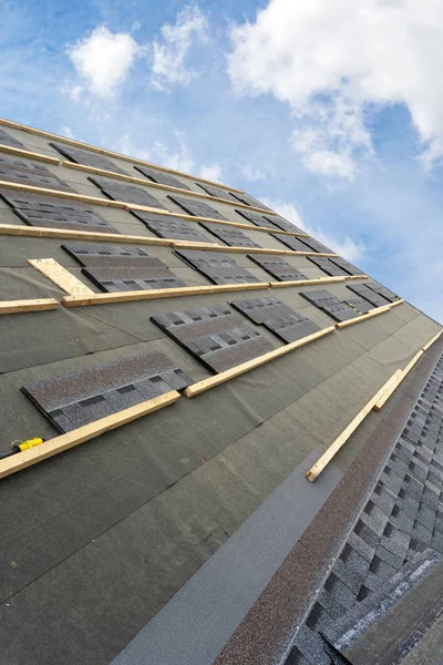 Asphalt tile roof on new house under construction — Stock Photo, Image