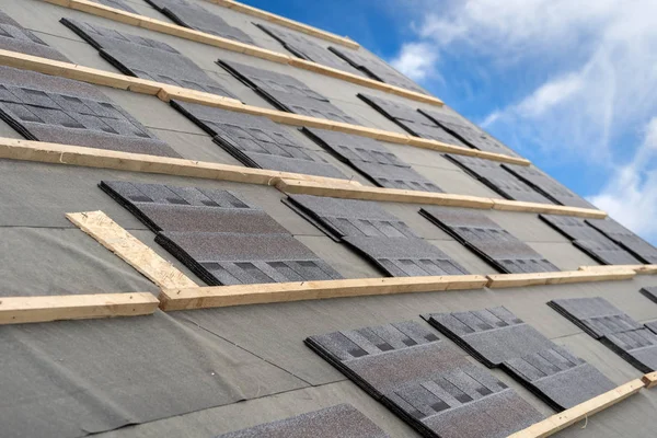 Asphalt tile roof on new house under construction