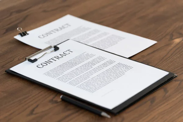 Documents and contract on wooden table in office — Stock Photo, Image