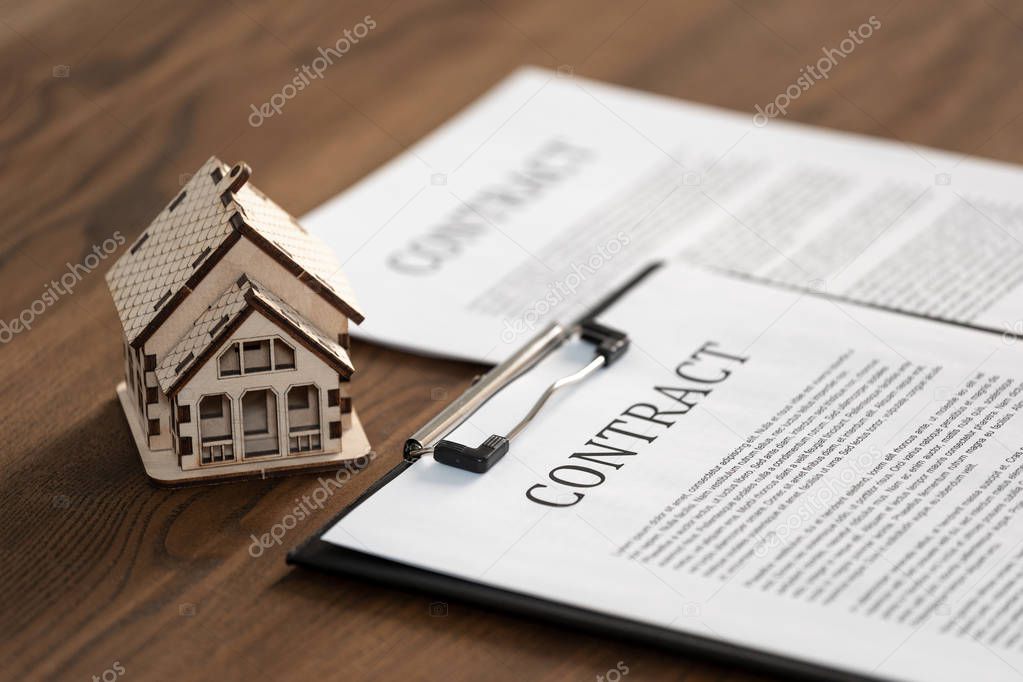 Documents and contract on wooden table in office