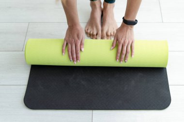 Genç sportif kadın yere fitness mat yayılır 