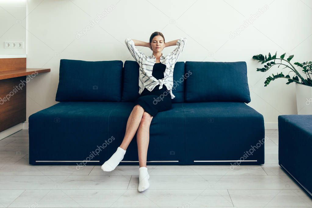 Young adult woman resting at home after work
